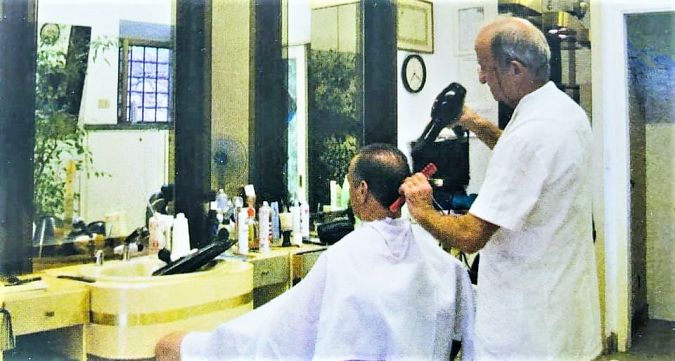 Il barbiere Franco al lavoro